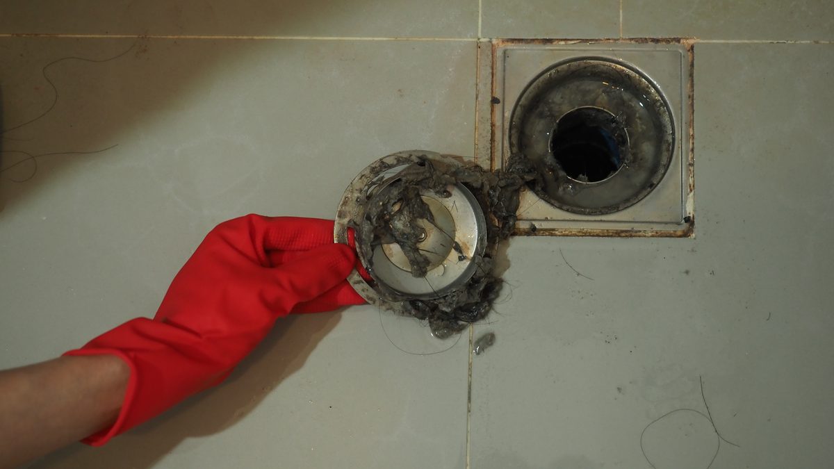 Blocked floor drain with soiled pipework around it